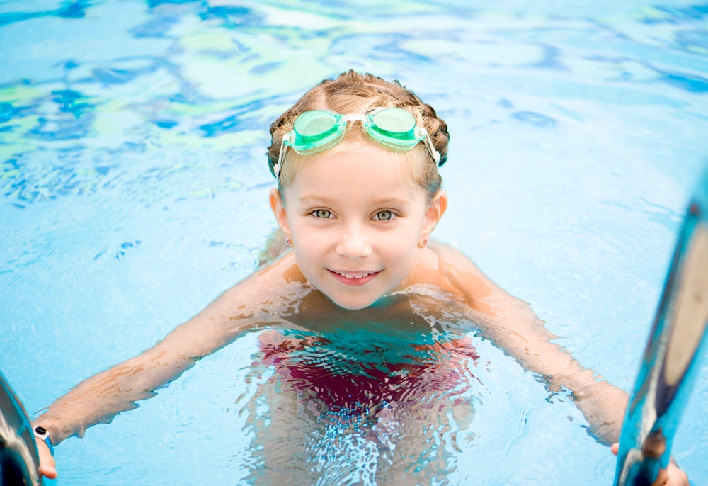 kid floating in pool