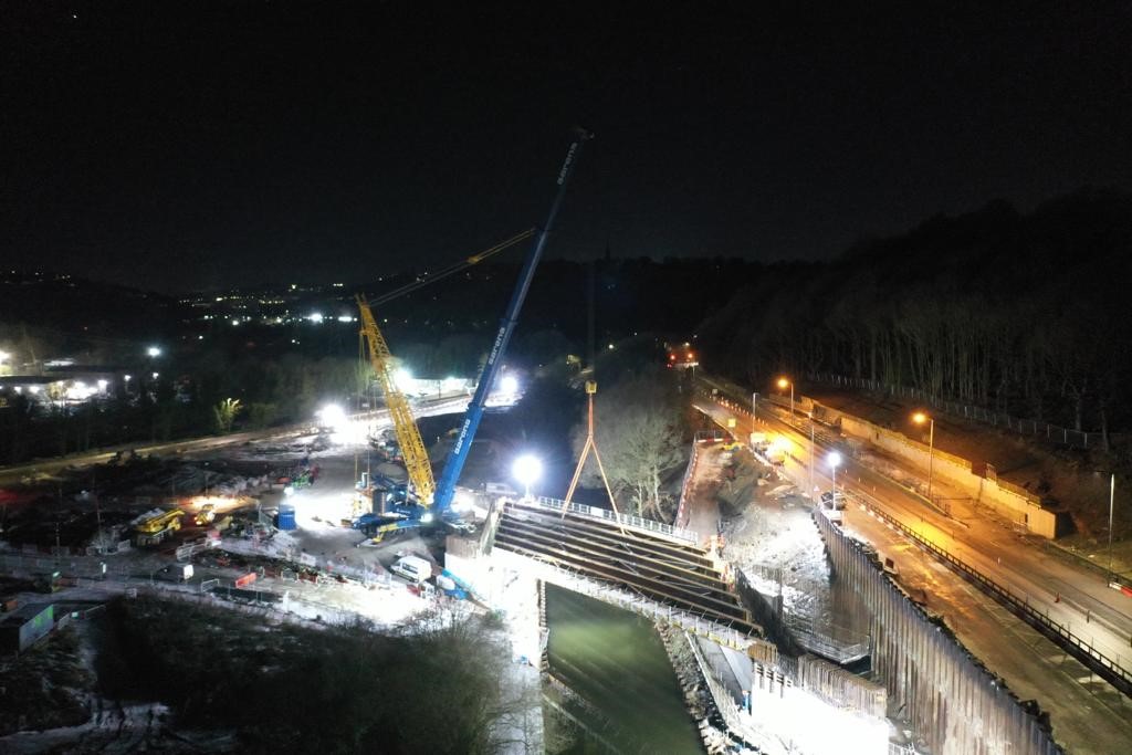 Huge crane lifting beams for a bridge into place at Salterhebble