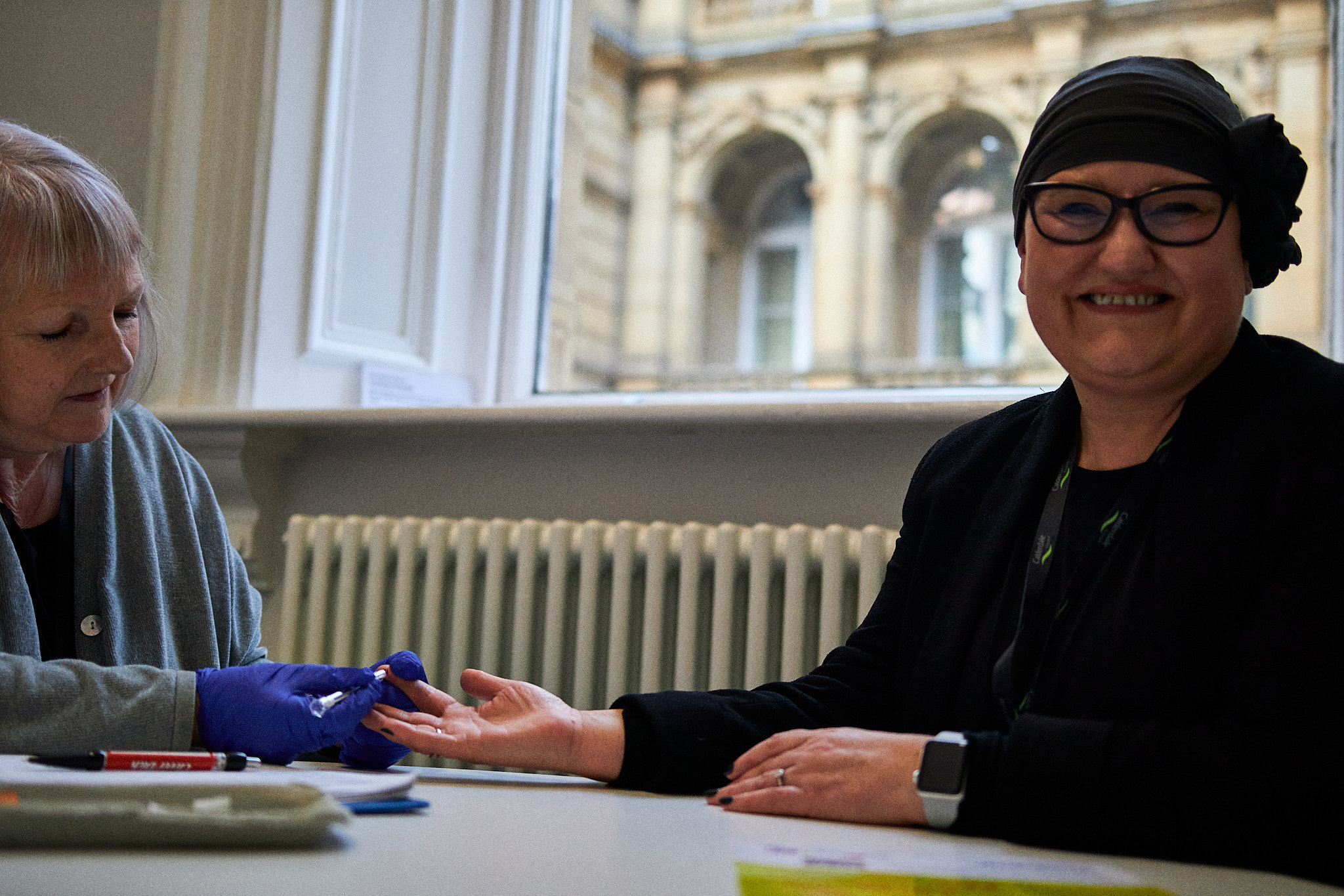 The Council's Director for Public Health, Debs Harkins, taking a finger prick test for HIV