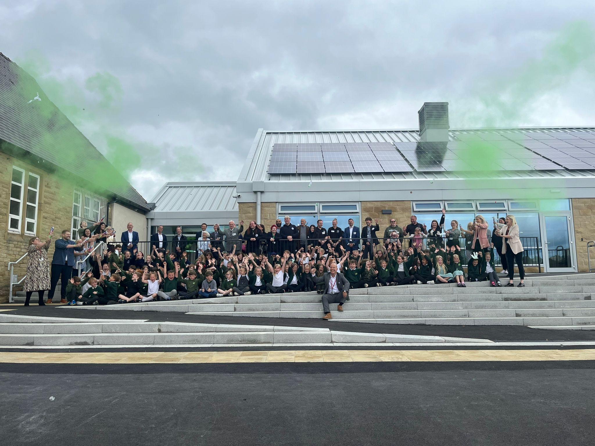 Staff and pupils celebrate the opening of Ash Green School's new building