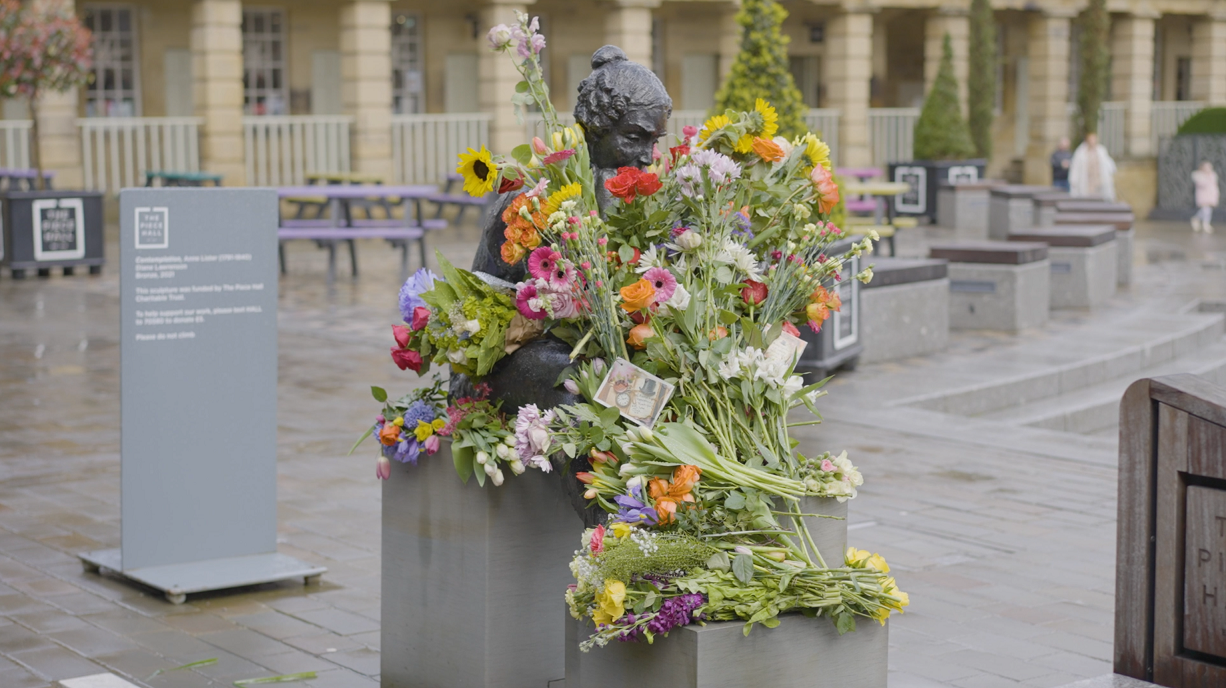 Anne Lister sculpture with flowers