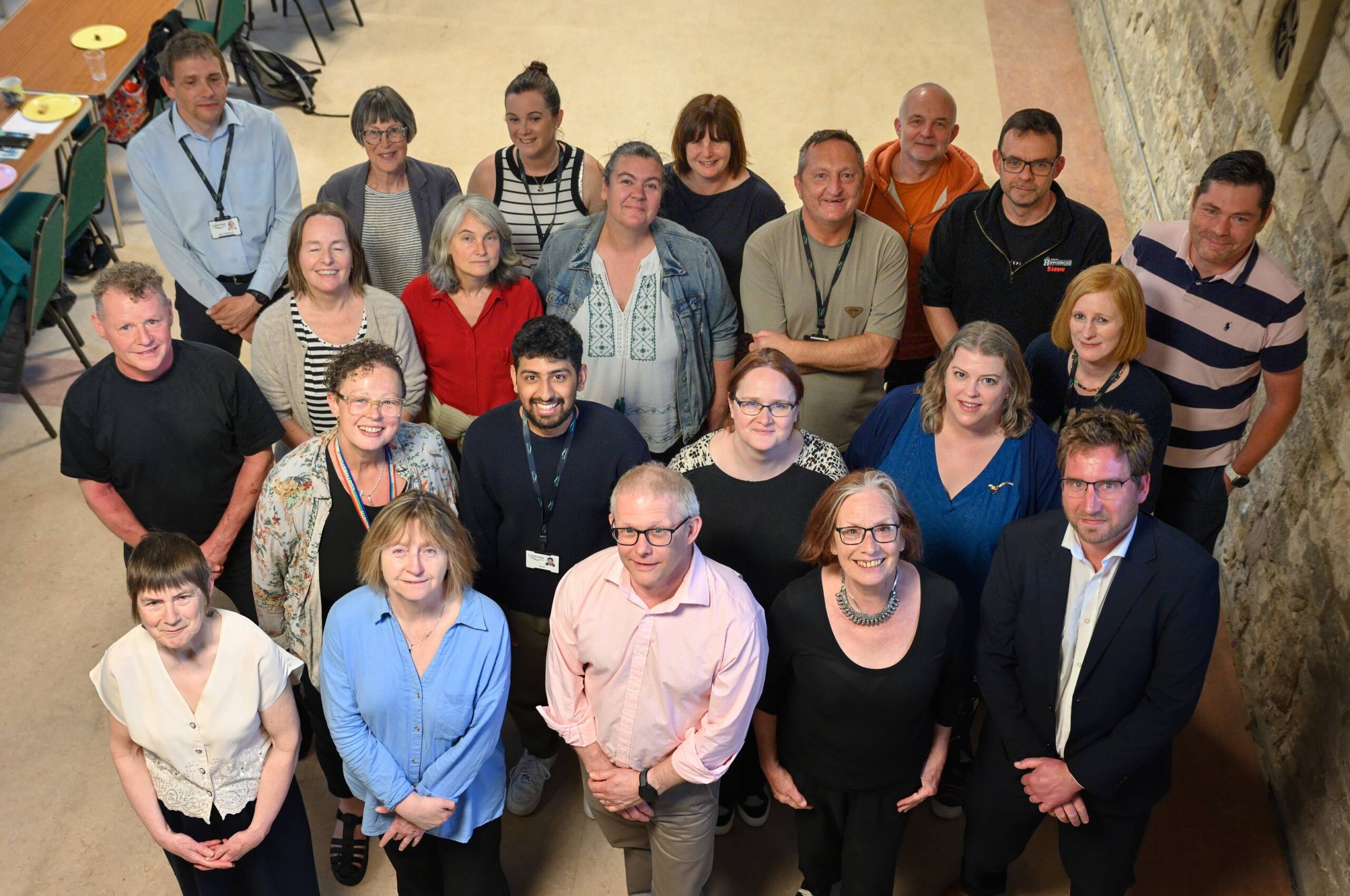 Group of people looking up at camera, celebrating work in Todmorden