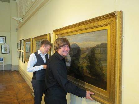 Apprentices hanging artwork