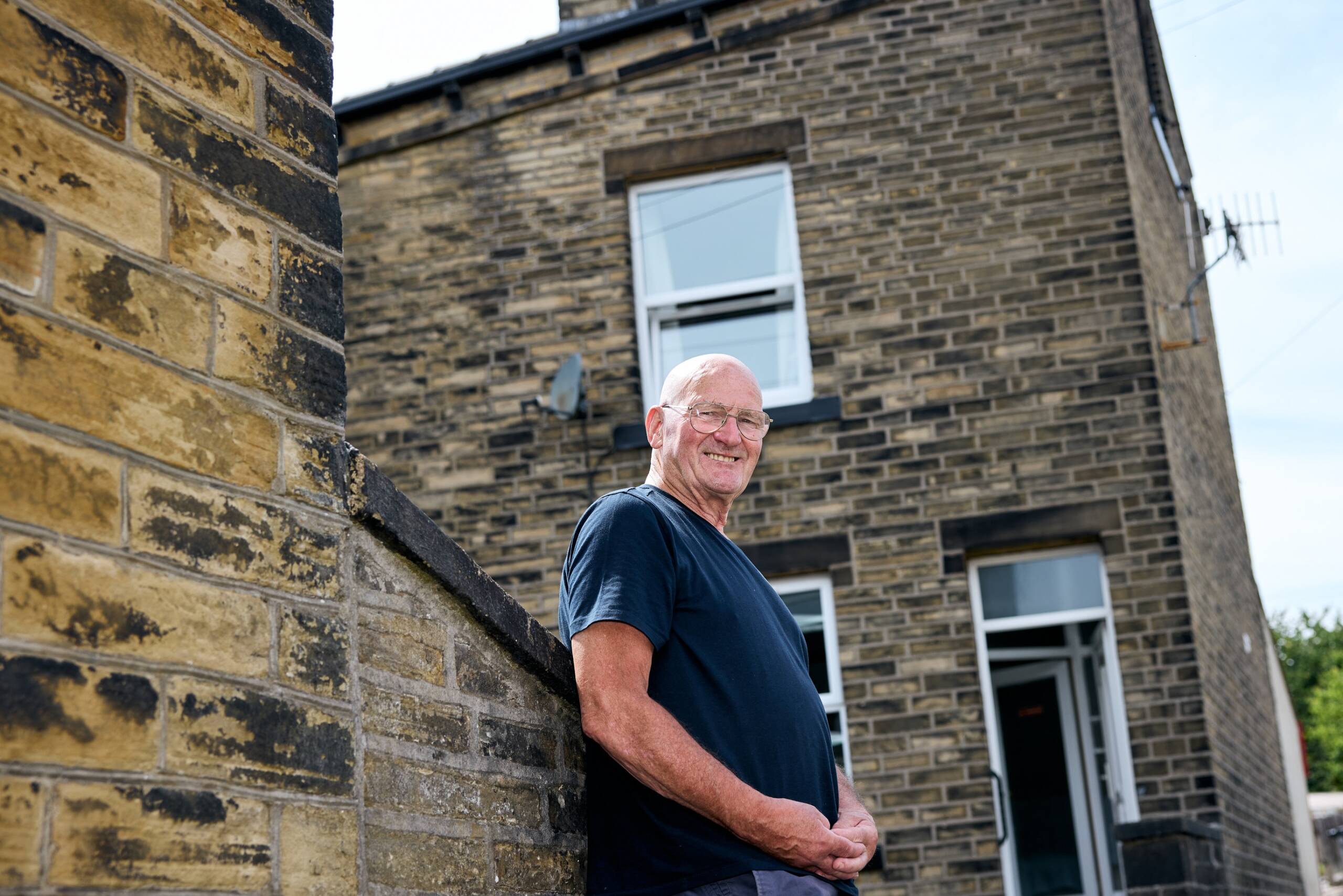 Man outside home which has benefitted from insultation