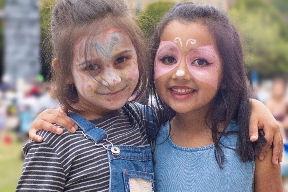 Young people with faces painted enjoy school summer holiday sessions