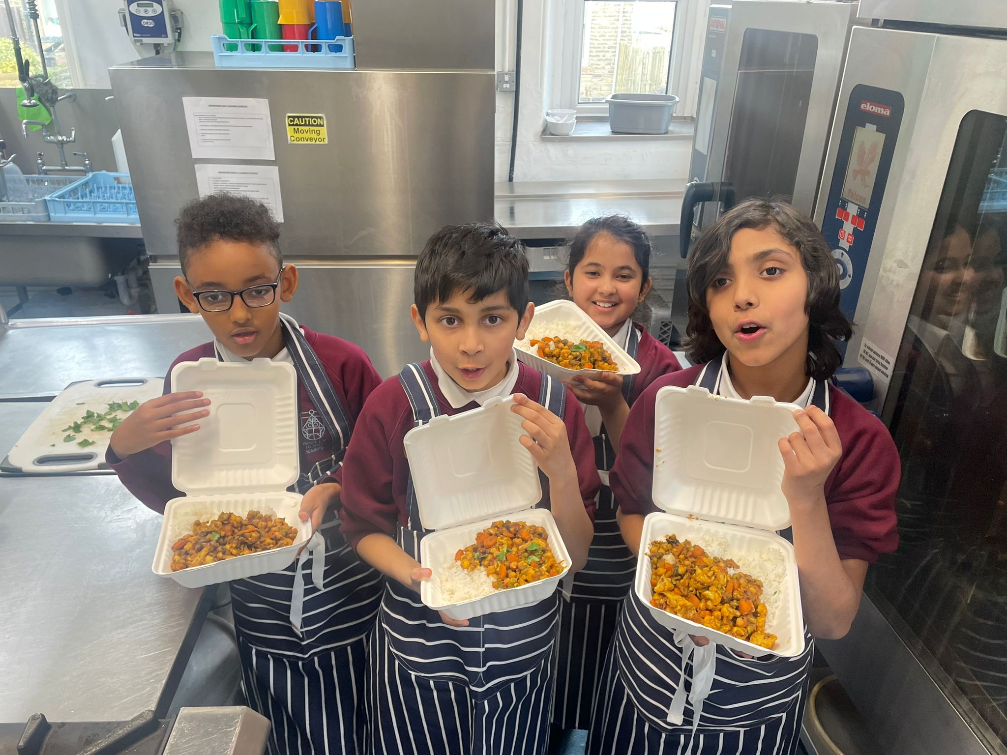 Pupils at Warley Road Primary Academy showing the food they made in Family Cook Clubs