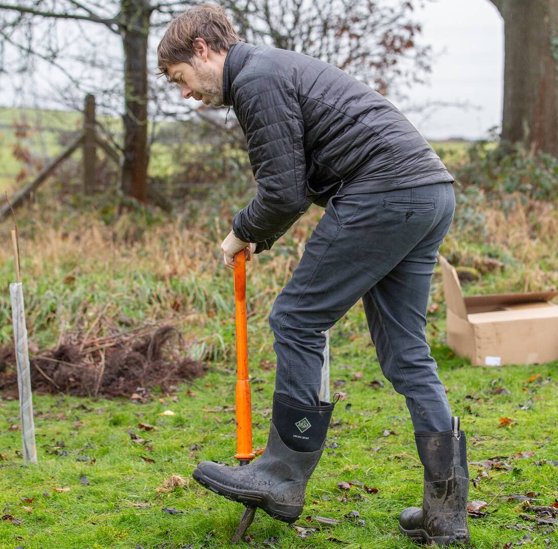 Cllr Scott Patient with spade digging as part of tree planting at Park Wood
