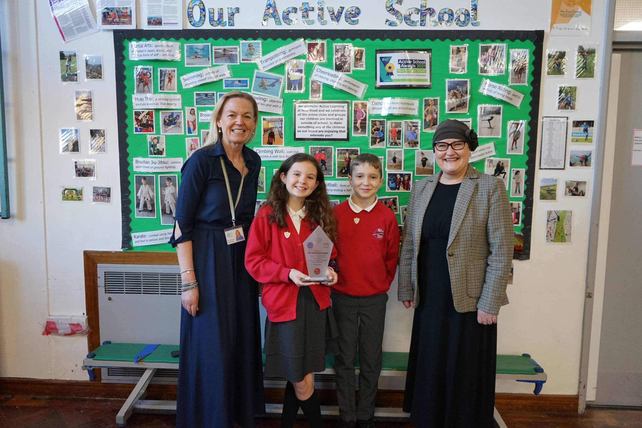 Pupils and headteacher at New Road Primary receiving award