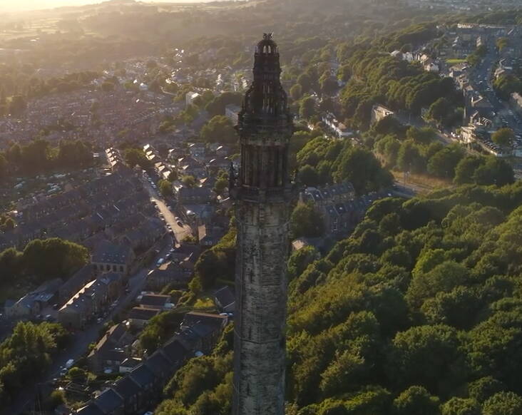 Wainhouse Tower from above, surrounded by trees and buildings