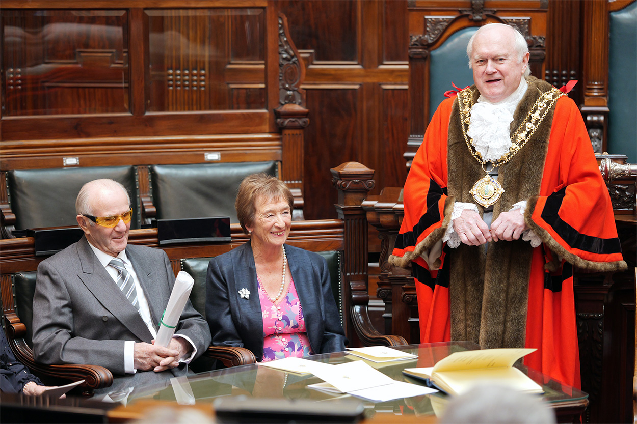 Colin and Gillian Greenwood get the Freedom of the Borough scroll from the Mayor of Calderdale at Halifax Town Hall