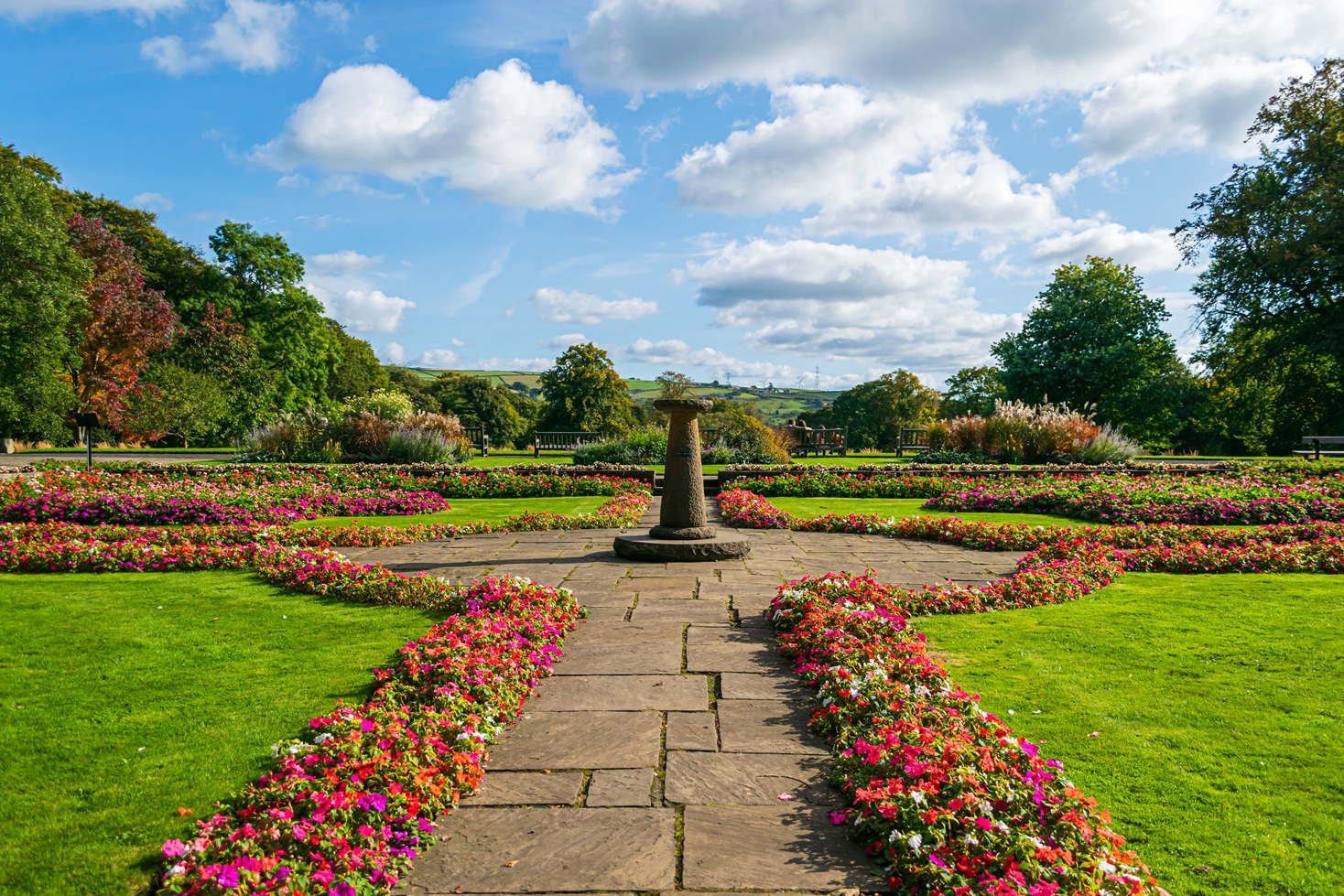 View of flower beds and blue sky at Manor Heath Park, Halifax